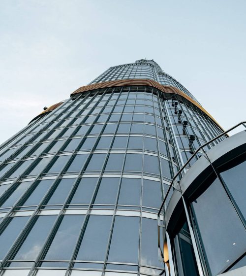 tall-glass-building-against-blue-sky-view-from-th-2023-11-27-05-02-25-utc.jpg